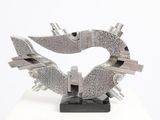 a metal sculpture of a heart on a white surface