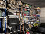 a garage with a lot of tires on the shelves