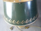 a green lamp with a gold leaf design on it