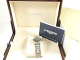 a watch in a box with a business card in it