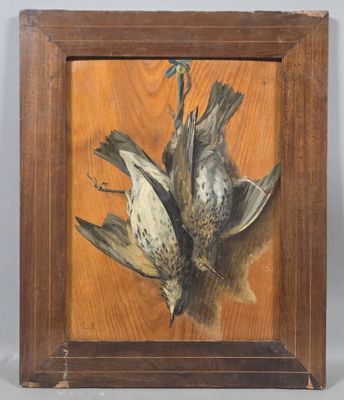 painting of two dead birds in a wooden frame on a table