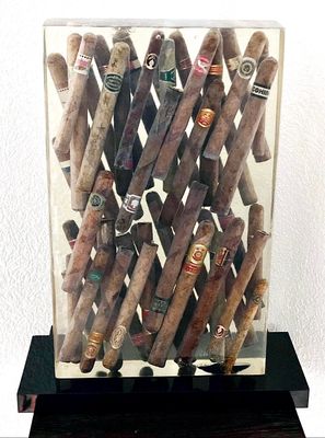 a display of cigars in a glass case on a table