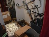 a room with a bunch of items in it and a red curtain