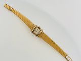 an image of a gold watch with diamonds on a white surface