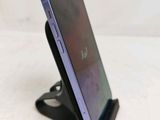 a close up of a cell phone on a stand on a table