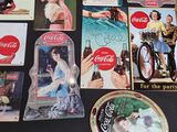 many coca cola advertising items on the table