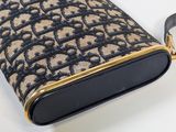 a black and tan purse on a white table