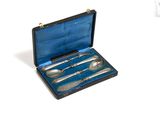 a silverware set in a black case on a white surface