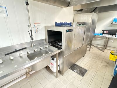 a kitchen with a sink, stove, and refrigerator in it