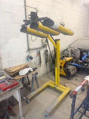 a car being worked on by a mechanic in a garage
