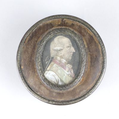 an old picture of a man in a military uniform in a wooden frame