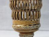 a vase that is sitting on a white surface