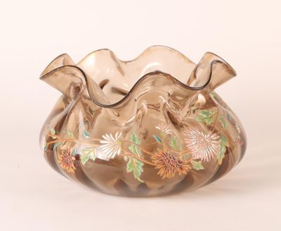 a glass vase that has a floral design on it