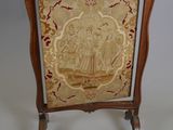 an old chair with a gold and red design on the back