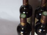 two bottles of wine sitting next to each other on a table