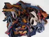 a pile of ties on a table with a white background