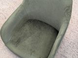 a green chair that is sitting on the floor