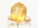 an image of a ring with a large yellow stone in it