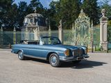 a blue car that is parked in front of a gate