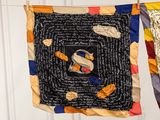 several pieces of fabric hanging on a clothes line with a picture of a cat