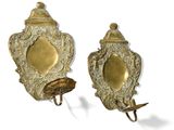 pair of antique brass wall sconces with a bird on one of them