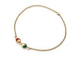 a gold bracelet with a green, red and white bead