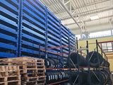 a large amount of pallets and chairs in a warehouse