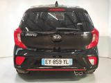 the back end of a small black car with a red tail light