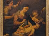 une image représentant un tableau où l'on voit une femme tenant un bébé dans une crèche