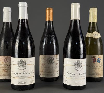 several bottles of wine are lined up on a table