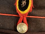 a brown hat with a red ribbon around it