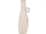 a white vase with a yellow top sitting on a white surface