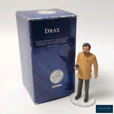 a toy figure of a man standing next to a box of drax