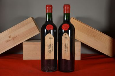 two bottles of wine sitting next to each other on a table
