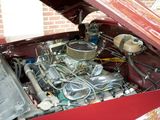 a red car with an engine in it ' s trunk
