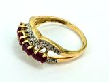 an image of a gold ring with a ruby stone and diamonds
