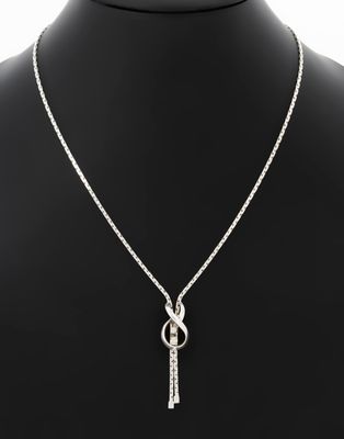 a silver necklace with a knot and a chain on a mannequin