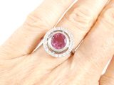 an image of a woman ' s hand with a pink diamond ring on it