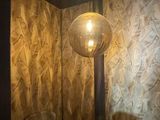 a chair and a lamp in the corner of a room