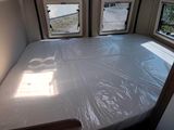 a bed with a sheet covering it in a room