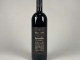 a bottle of red wine sitting on top of a white table