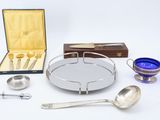 a silver tray with spoons, spoons, and other items on it