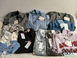 a lot of clothes that are sitting on the floor