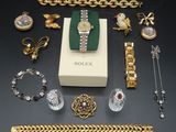 an assortment of jewellery including a watch, bracelets, and other items