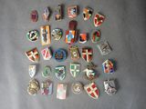 a lot of different types of badges on a table
