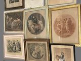 many framed pictures on the wall of this room