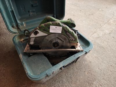 a green case with a circular saw in it