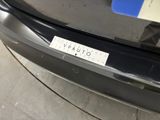 the bumper of a car with a sticker on it