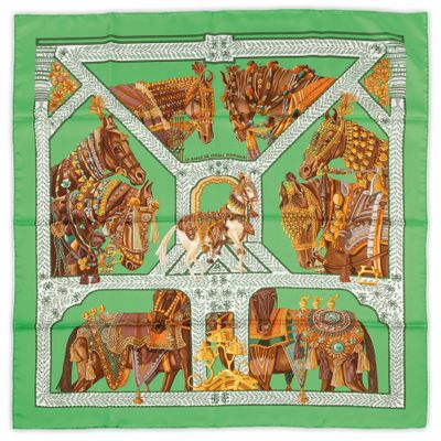 a green scarf with a picture of elephants and people on it