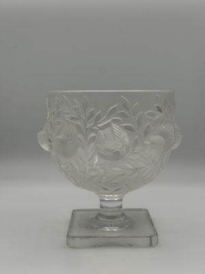 a clear glass vase with a flower design on it